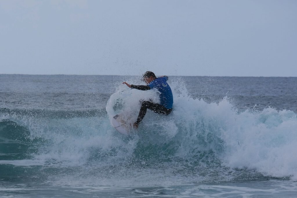 Thrilling surf moment in the pristine waves of the Azores ocean. A surfer carving through the water, embracing the energy of the Atlantic, capturing the essence of exhilarating surf adventures in this stunning Azorean seascape.